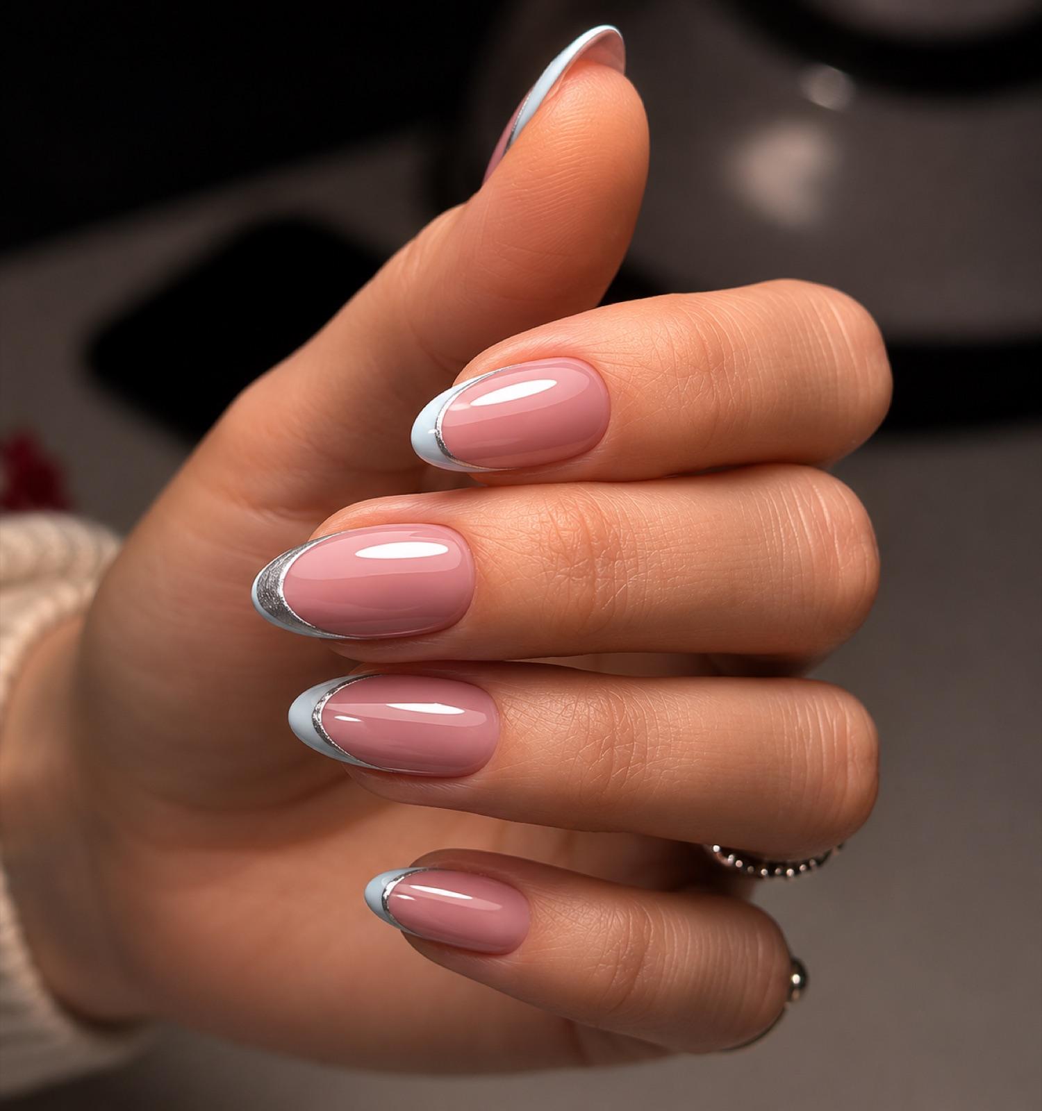 Almond gel nails with a chrome-silver French tip and a glossy finish at Empire in Corby