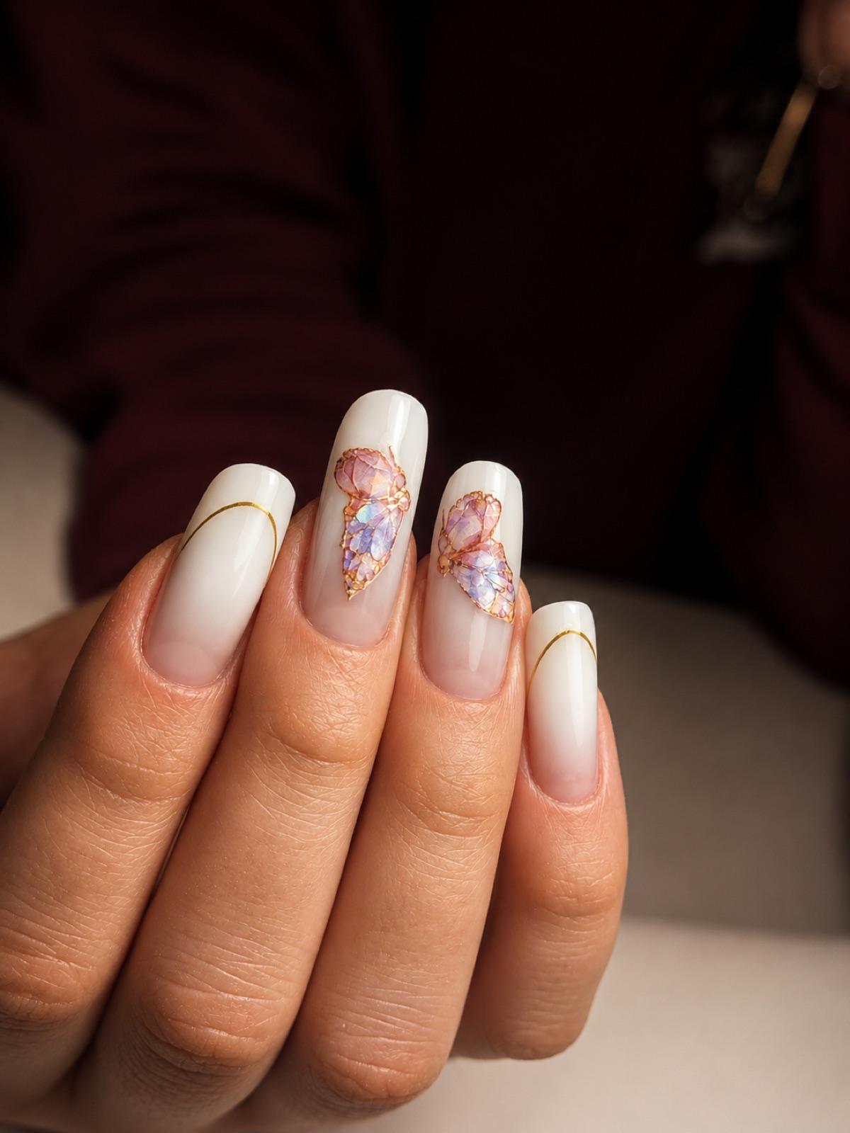 White coffin nails with delicate hand-painted floral detail at Empire nail salon in Corby